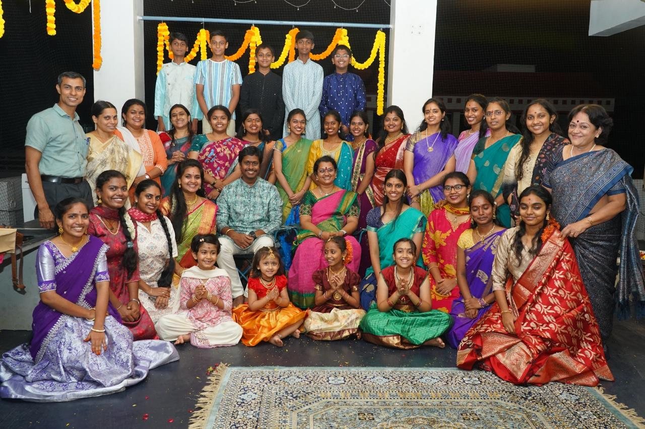 Founders, students, and families gathered together for a festive group photo